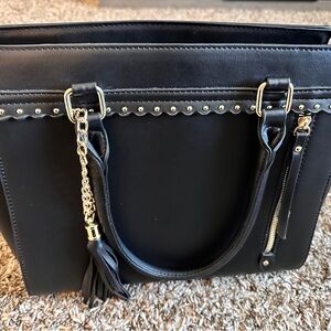 Black Handbag with Gold Accents and Tassel